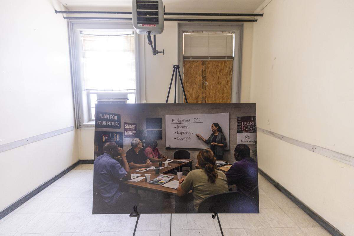 An AI rendering of a classroom sits on an easel inside an abandoned room at the former Wayne County Correctional Center in Goldsboro. The rendering shows plans by Kerwin Pittman to transform the decommissioned prison into a transitional workforce development campus for formerly incarcerated people.