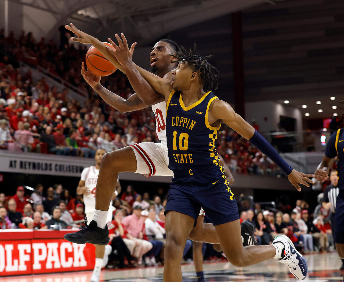 N.C. State’s Marcus Hill drives to the basket past Coppin State’s Camaren Sparrow during the first half of the Wolfpack’s game on Tuesday, Dec. 10, 2024, at Reynolds Coliseum in Raleigh, N.C.