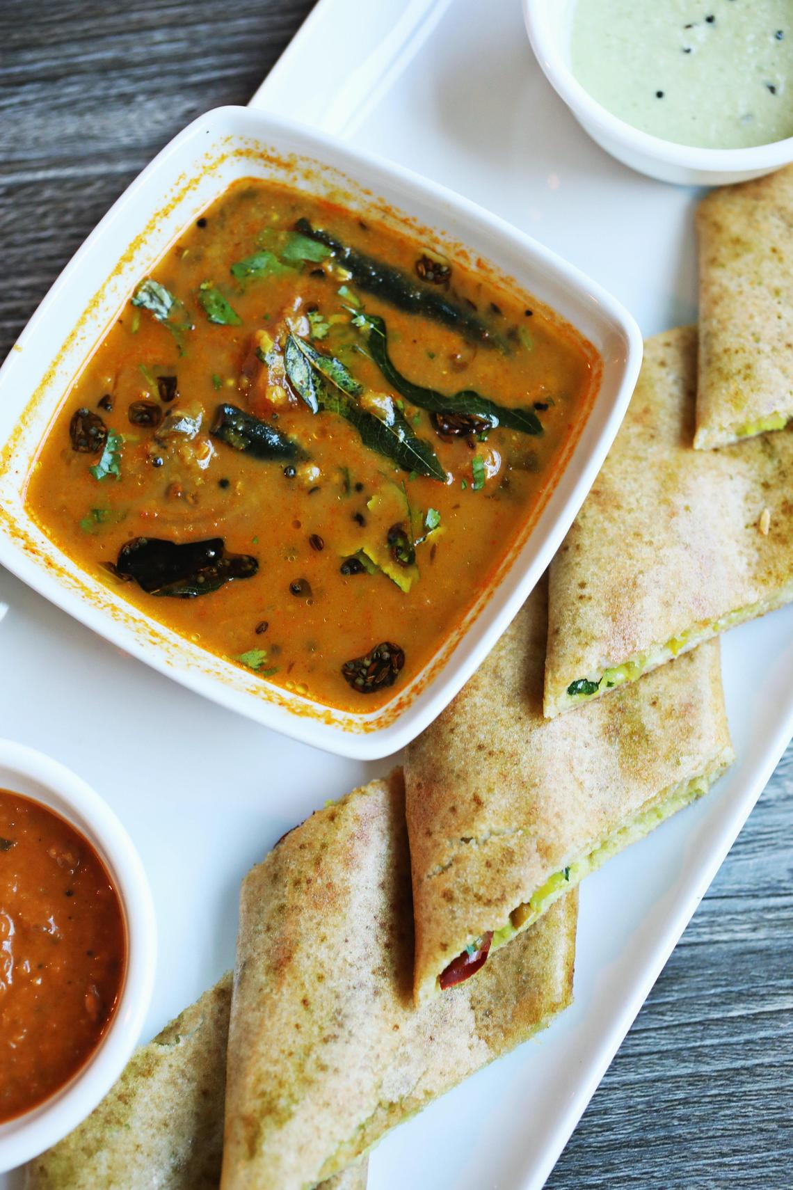 Lime & Lemon’s avocado dosa, which presents the rice batter crepe not in its customary rolled form, but as thin diamond-shaped ÒsandwichesÓ with a filling of mashed avocado, cheese, and spicychutney.