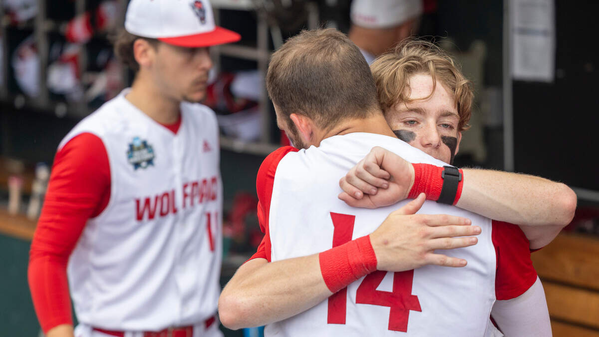 N.C. State short stop Brandon Butterworth embraces catcher Jacob Cozart (14) following the Wolfpack’s season ending 5-4 loss to Florida in game seven of the College World Series on Monday, June 17, 2024 at Charles Schwab Field in Omaha, Nebraska.