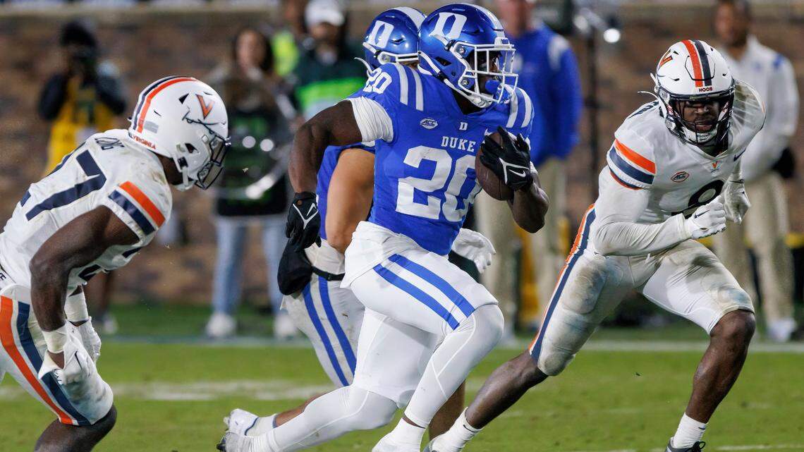 Duke’s Jaquez Moore (20) carries the ball for a touchdown past Virginia’s Langston Long, left, and Darrius Bratton (8) during the second half of an NCAA college football game in Durham, N.C., Saturday, Oct. 1, 2022. (AP Photo/Ben McKeown)