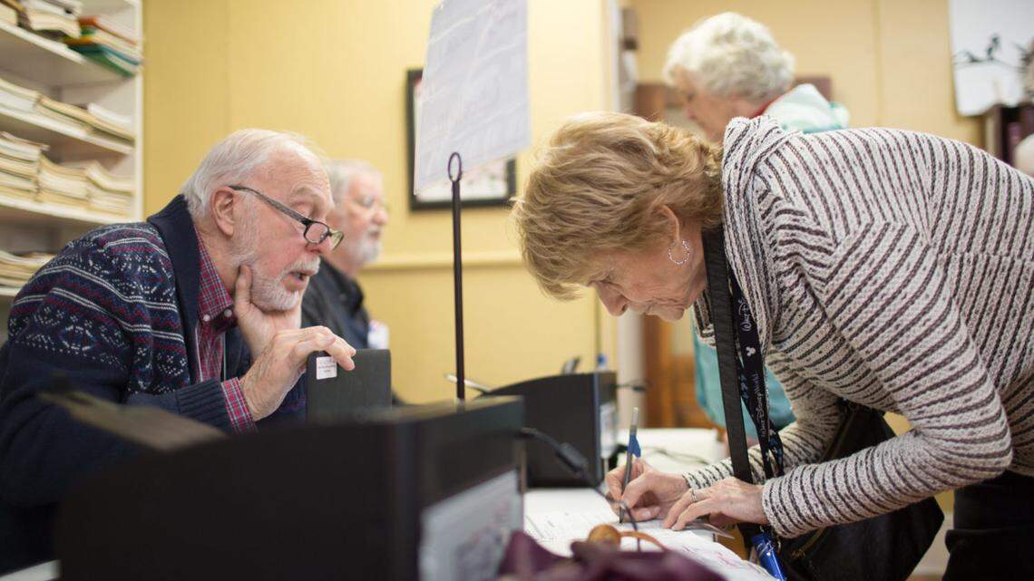 Gay Ferguson, right, speaks with election official Carter Blaisdell before voting at the First Baptist Church of Black Mountain polling place on March 3 in Buncombe County. Western North Carolina counties are gearing up for a second primary to resolve the Republican nomination for the 11th Congressional District.