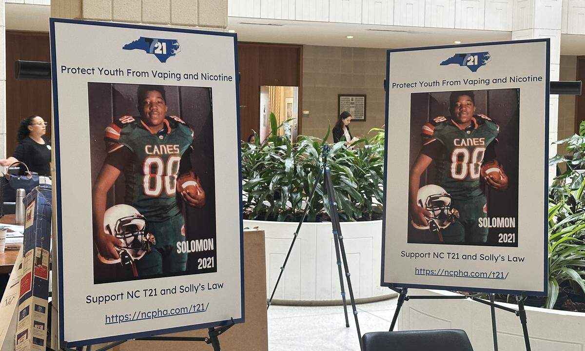 Signs featuring Solomon Wynn, a New Hanover high schooler who died in 2023 from a vaping-related illness, are displayed during an advocacy day at the NC legislature to raise the minimum age for tobacco and nicotine product sales to 21.
