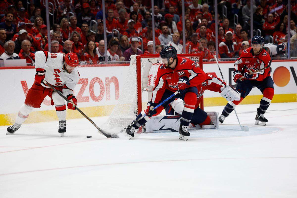 Carolina Hurricanes left wing William Carrier (28) prepares to shoot the puck on Washington Capitals goaltender Logan Thompson (48) as Capitals defenseman Matt Roy (3) defends in the second period in game five of the second round of the 2025 Stanley Cup Playoffs at Capital One Arena.