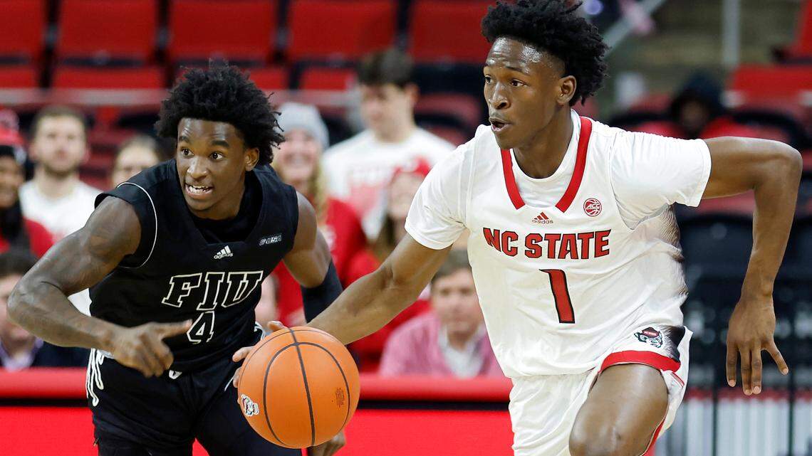 North Carolina State Wolfpack guard Jarkel Joiner pushes the ball past Florida International Golden Panthers guard Arturo Dean during the first half of a men’s basketball game at PNC Arena on Tuesday, Nov. 15, 2022, in Raleigh, N.C.