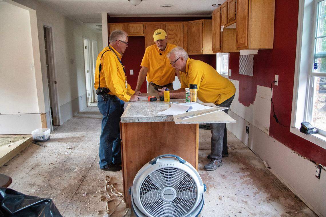 From left, Larry High, executive director Richard Brunson and Bill Martin of the NC Baptist Men go over plans to repair a home damaged by flooding from Hurricane Florence Thursday, Nov. 1, 2018 in Lumberton.
