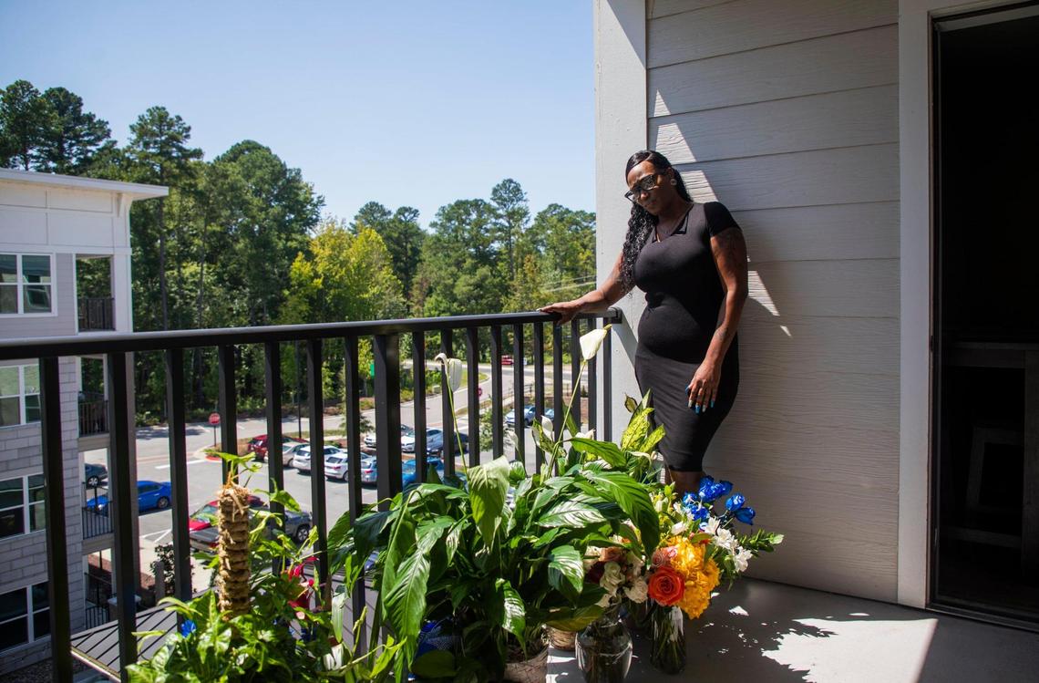 Kenita Stubbs stands for a portrait with the flowers from the funeral of her 15-year-old son Michael Harris who was fatally shot early Sunday morning, Aug. 23, 2020, in Durham, N.C., on Thursday, Sep. 3, 2020, in Morrisville, N.C.