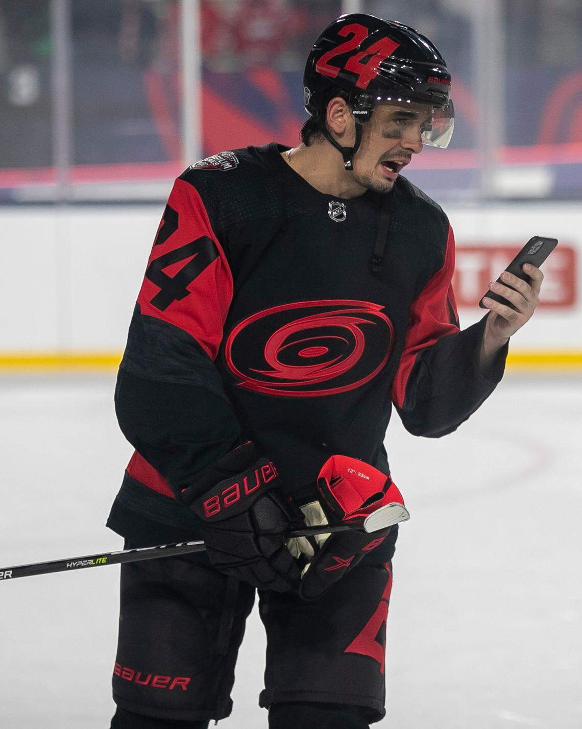 Carolina Hurricanes’ Seth Jarvis (24) talks on his phone before leaving the ice, following their 4-1 victory over the Washington Capitals in the Stadium Series game on Saturday, February 18, 2022 at Carter-Finley Stadium in Raleigh, N.C.