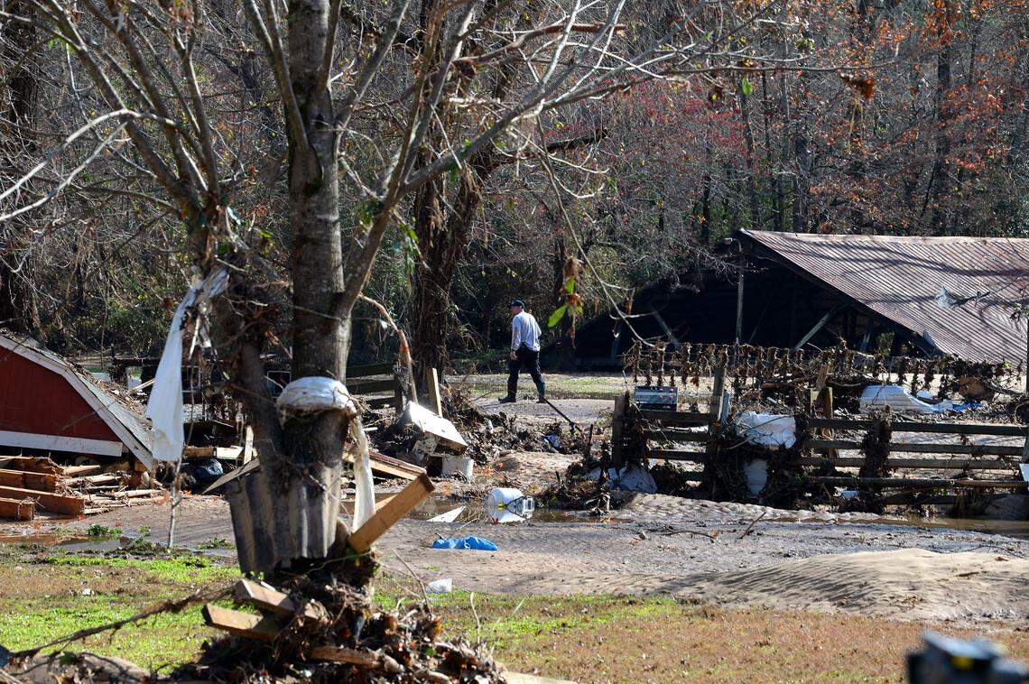 A rescue worker is surrounded by the destroyed property of residents at the Hiddenite Family Campground in Hiddenite, NC on Friday, November 13, 2020. Five people were killed after flooding from the Yadkin River during heavy rains across the region.