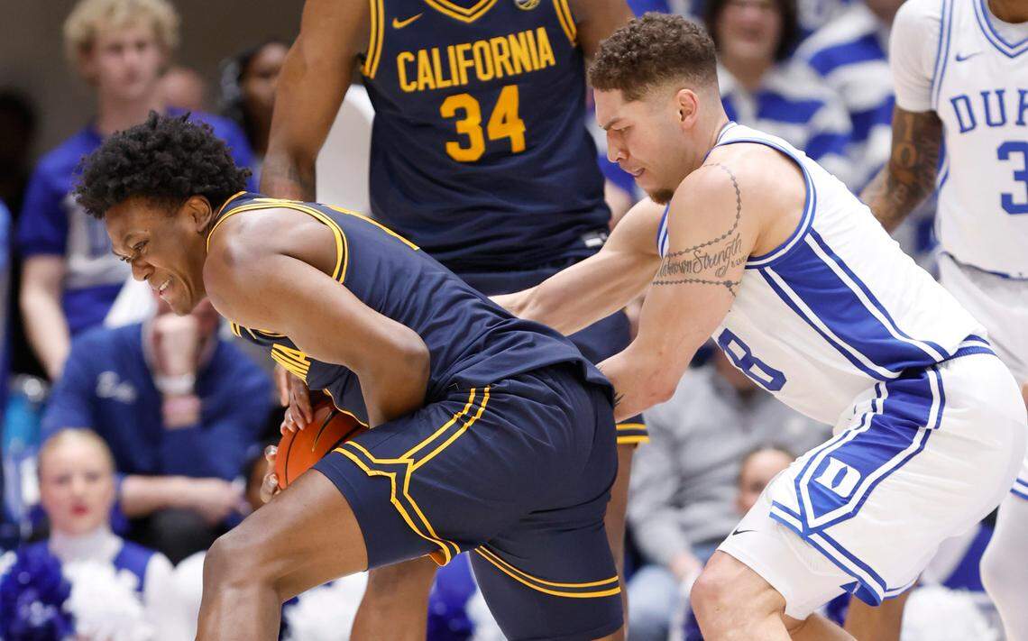 Duke’s Mason Gillis (18) fights California’s Joshua Ola-Joseph (1) for the ball during the second half of Duke’s 78-57 victory over Cal at Cameron Indoor Stadium in Durham, N.C., Wednesday, Feb. 12, 2025.