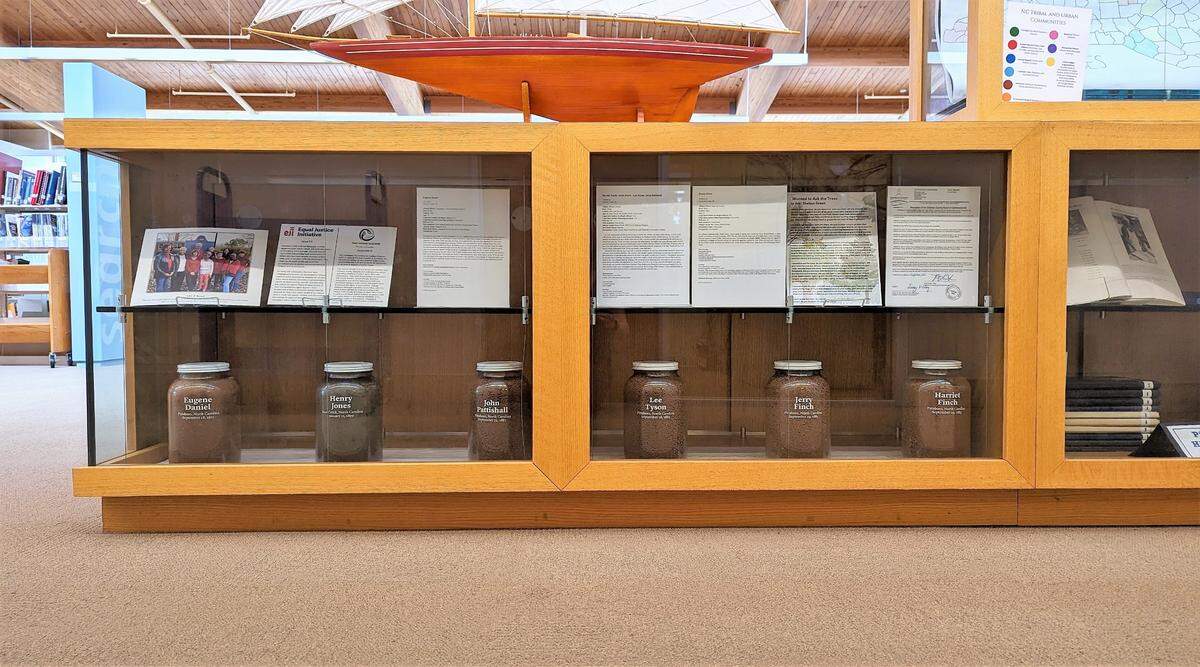A permanent exhibit at the Chatham Community Library is home to six jars of soil collected from each of the known sites where people were killed between 1885 and 1921.