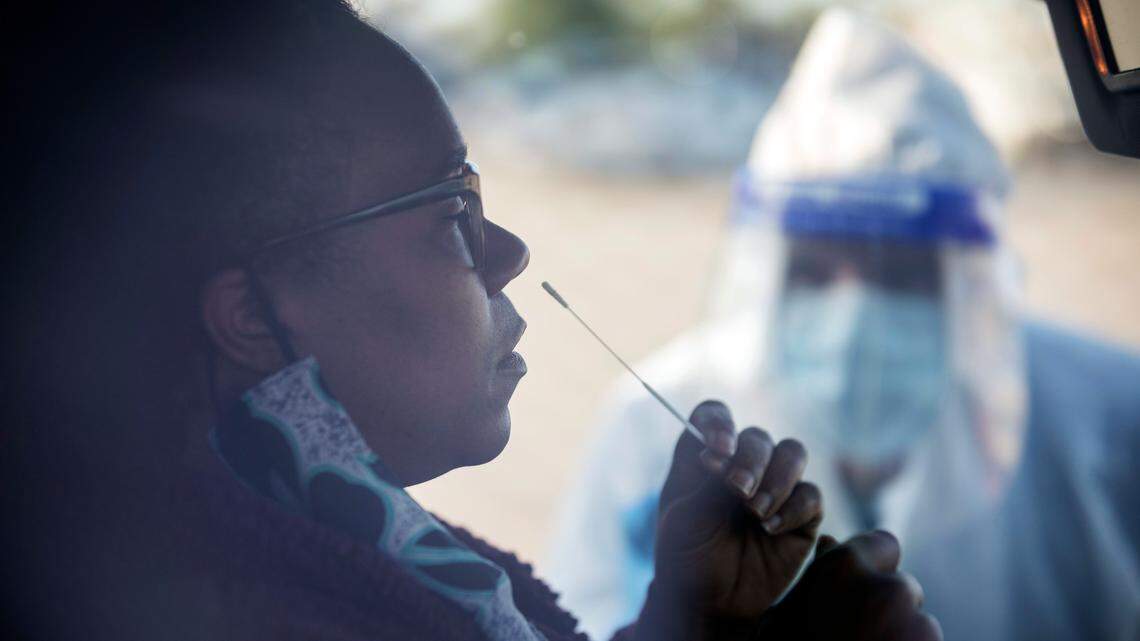 Tywanna Tinsley administers a COVID-19 test to herself while being instructed by phone by Walmart pharmacist Royanna Morris in the parking lot of the Walmart on Ramsey Street in Fayetteville, N.C. on Friday, May 15, 2020. The tests will be processed by eTrueNorth and are now available at this Walmart location to people who qualify and pre-register from 7a.m. to 9a.m. on Mondays, Wednesdays and Fridays.