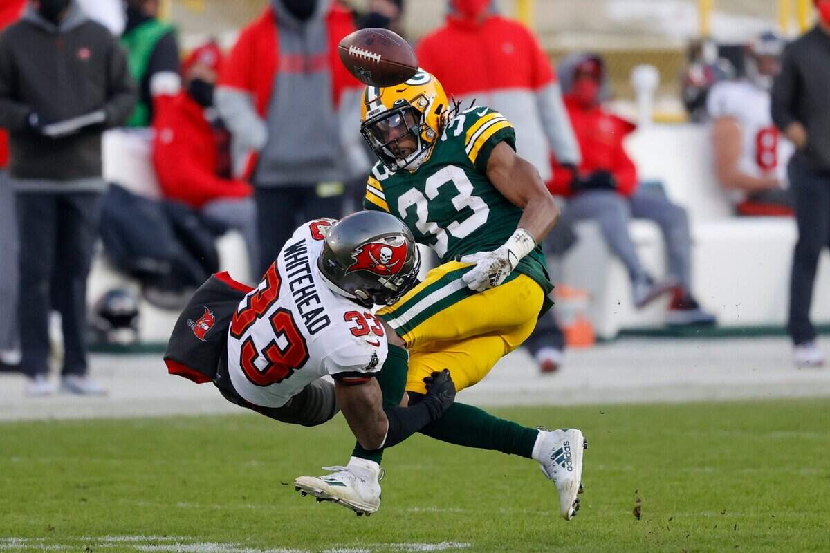 Green Bay Packers’ Aaron Jones (33) fumbles after being hit by Tampa Bay Buccaneers’ Jordan Whitehead (33) during the second half of the NFC championship NFL football game in Green Bay, Wis., Sunday, Jan. 24, 2021.
