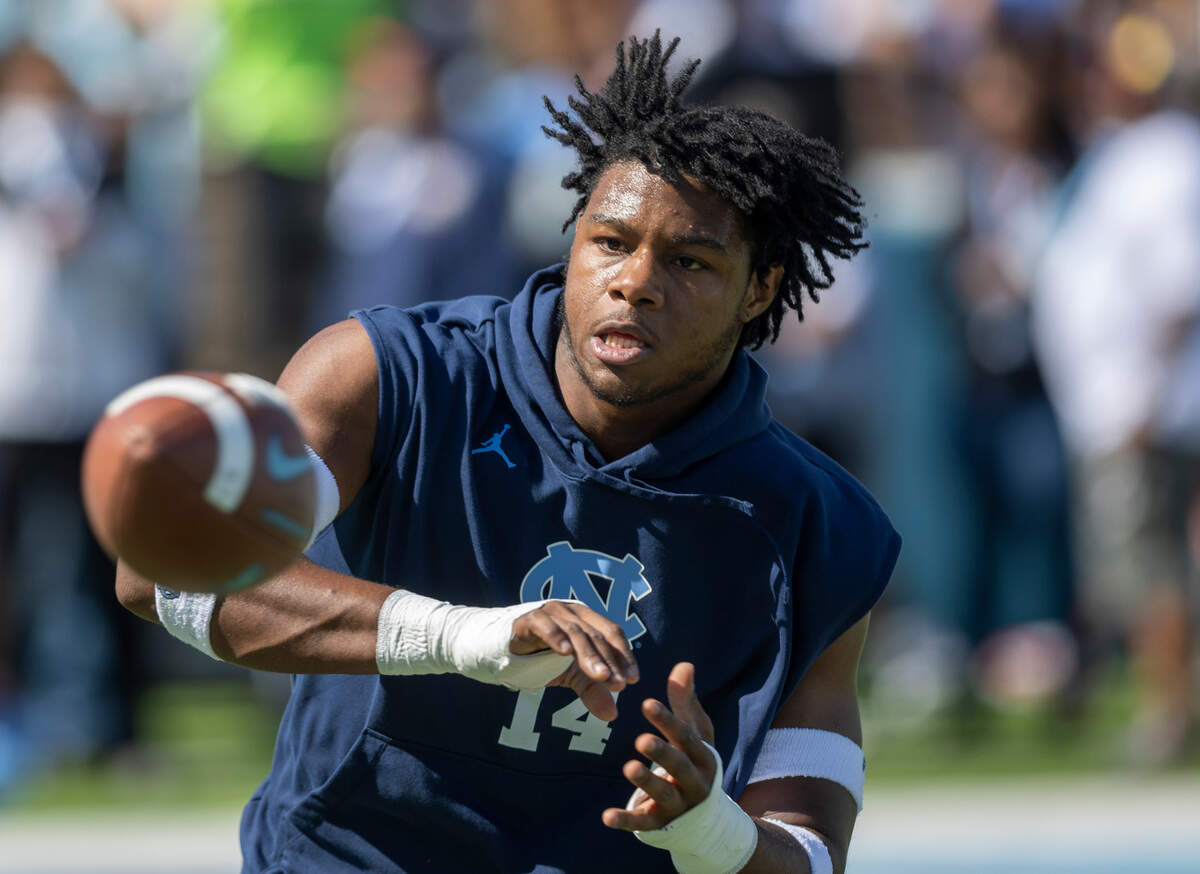 North Carolina’s Jaybron Harvey (14) warms up with his teammates for the Tar Heels’ game against Syracuse on Saturday, October 7, 2023 at Kenan Stadium in Chapel Hill, N.C.
