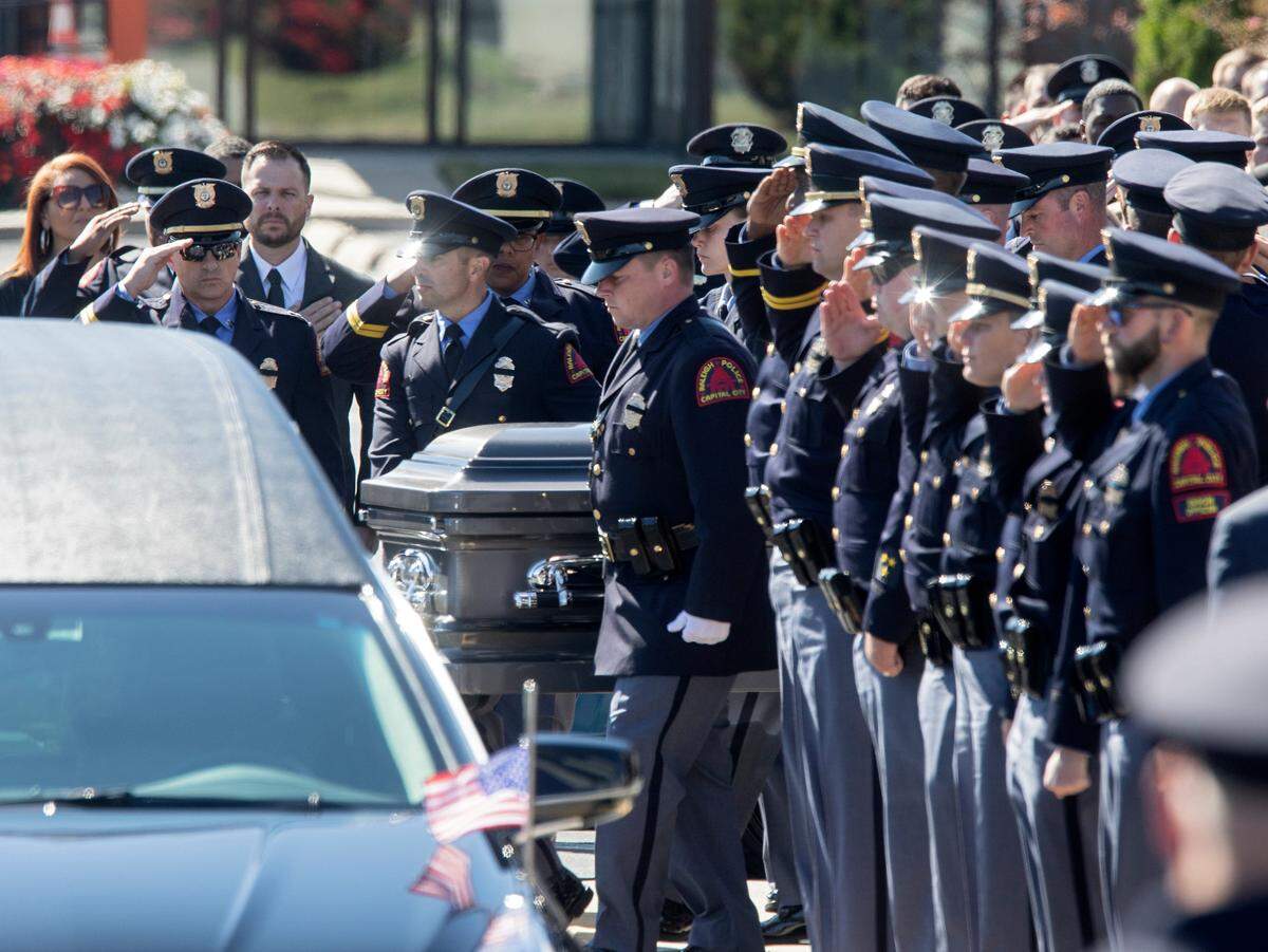 Police salute as the casket of Raleigh police officer Gabriel Torres leaves Cross Assembly Church following his funeral on Saturday, Oct. 22, 2022, in Raleigh, N.C. Torres, 29, was one of five people fatally shot near the Hedingham neighborhood on Oct. 13.