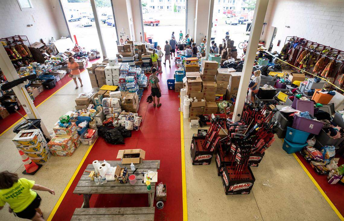 Ocracoke residents look through piles of supplies at the Ocracoke Volunteer Fire Department on Friday, Sept. 13, 2019. The building has served as a relief station since Hurricane Dorian flooded the island.