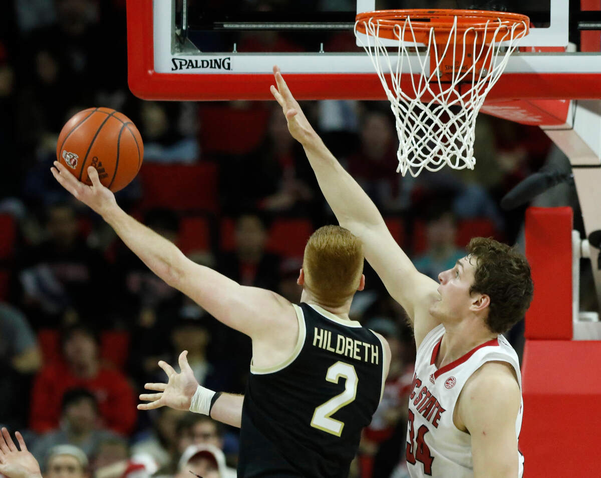 N.C. State’s Ben Middlebrooks defends a shot by Wake Forest’s Cameron Hildreth during the second half of the Wolfpack’s 83-76 win at PNC Arena on Tuesday, Jan. 16, 2024, in Raleigh, N.C.