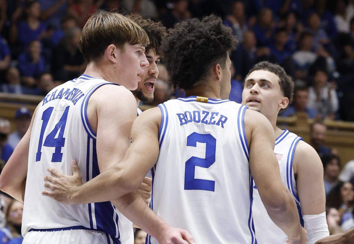 Duke’s Nikolas Khamenia (14) huddles with Cameron Boozer (12), Cayden Boozer (2) and Darren Harris (8) during Duke’s 96-71 exhibition victory over UCF on Oct. 21.