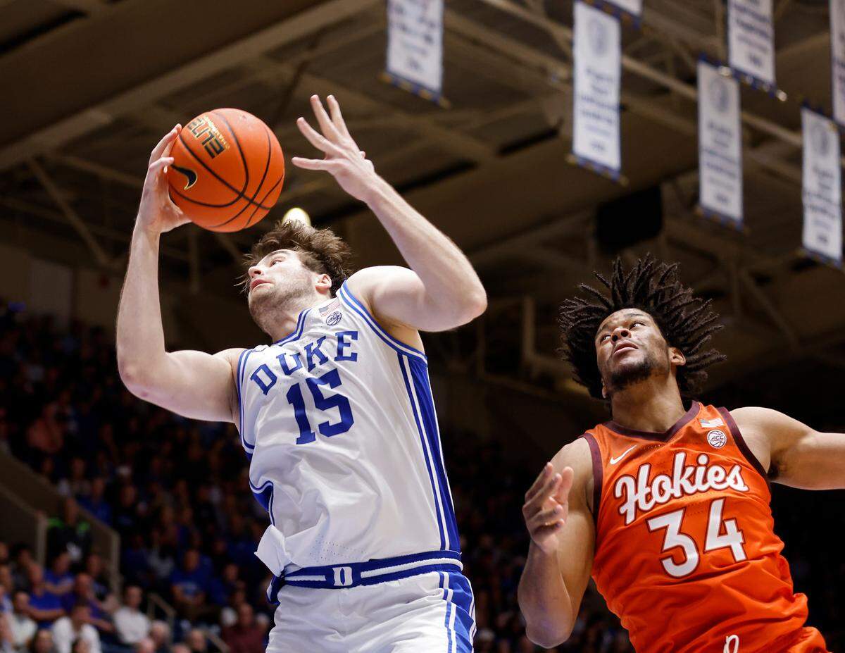 Duke’s Ryan Young grabs a loose ball away from Virginia Tech’s Mylyjael Poteat during the second half of the Blue Devils’ 81-65 win over Virginia Tech on Saturday, Feb. 25, 2023, at Cameron Indoor Stadium in Durham, N.C.
