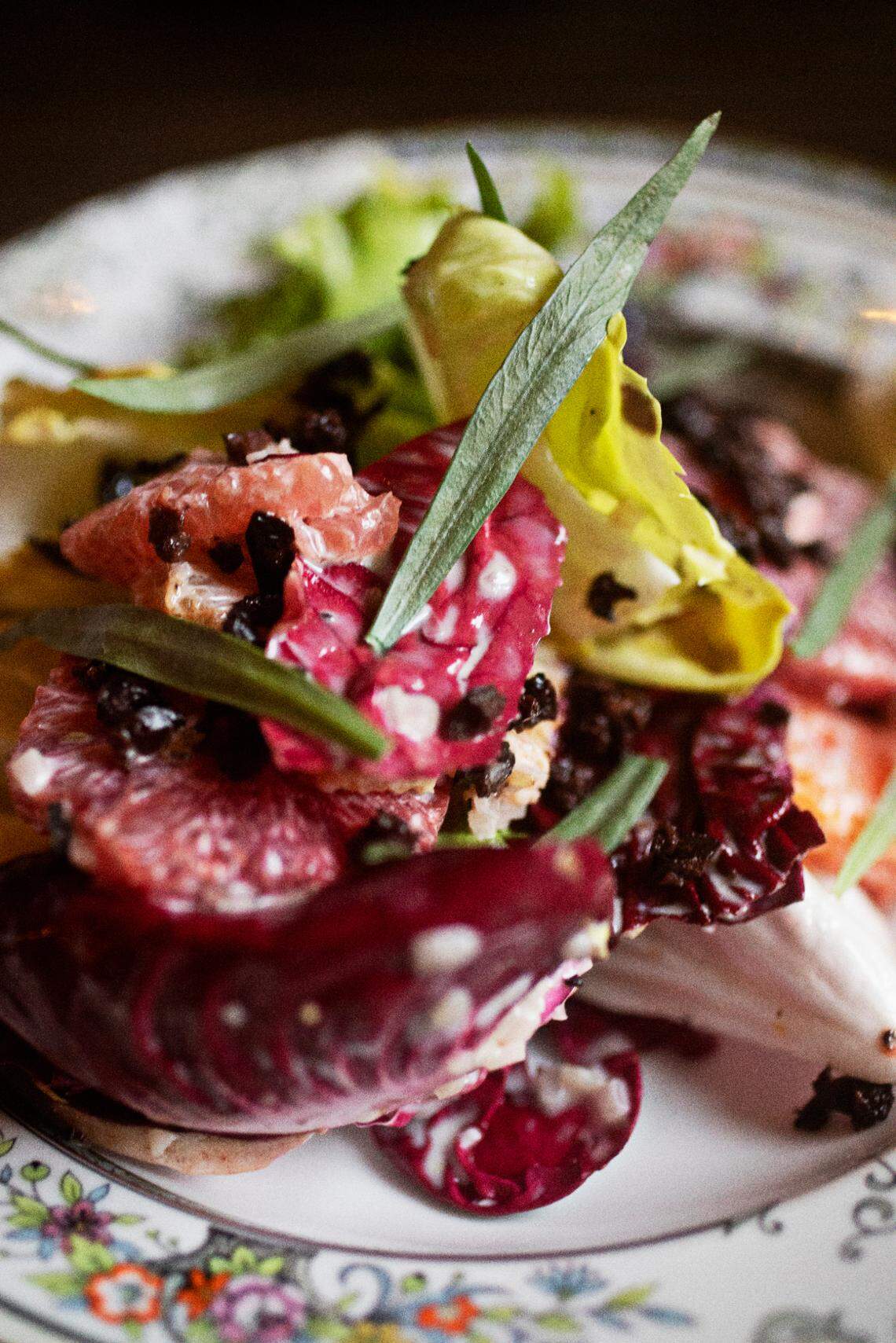 The chickories with olives, citrus, creamy white balsamic dressing and tarragon can be found on the snack menu at Littler in Durham on Thursday, Feb. 24, 2022.