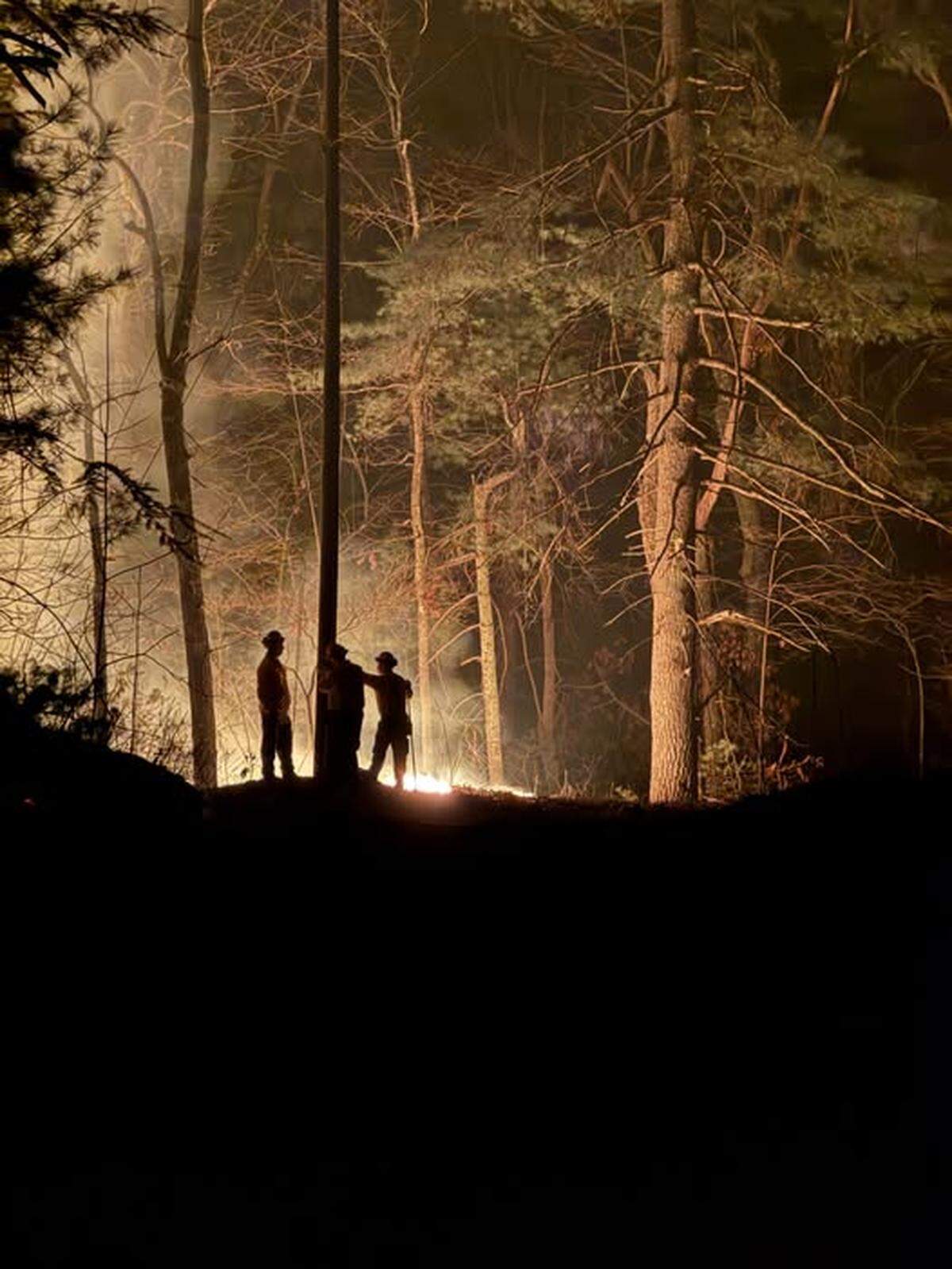 Dry conditions across most of North Carolina have contributed to a busy fire season in Spring 2025. As of Monday, May 5, dozens of fires were burning across the state, including on in Brunswick County that has torched 1,369 acres so far. Here, firefighters work to contain the Black Cove fire in Polk County in March 2025.