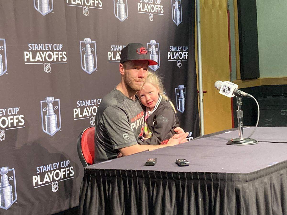 Carolina Hurricanes goalie Antti Raanta holds his daughter, Evelyn, as he answers media questions after a 3-2 win over the Boston Bruins in Game 7 at PNC Arena on May, 14, 2022.