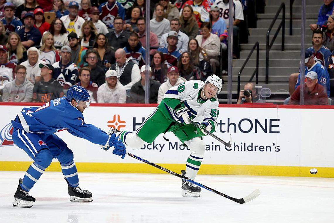 Eric Robinson (50) of the Carolina Hurricanes fires a shot against Devon Toews of the Colorado Avalanche to score in the first period at Ball Arena on October 23, 2025 in Denver, Colorado.