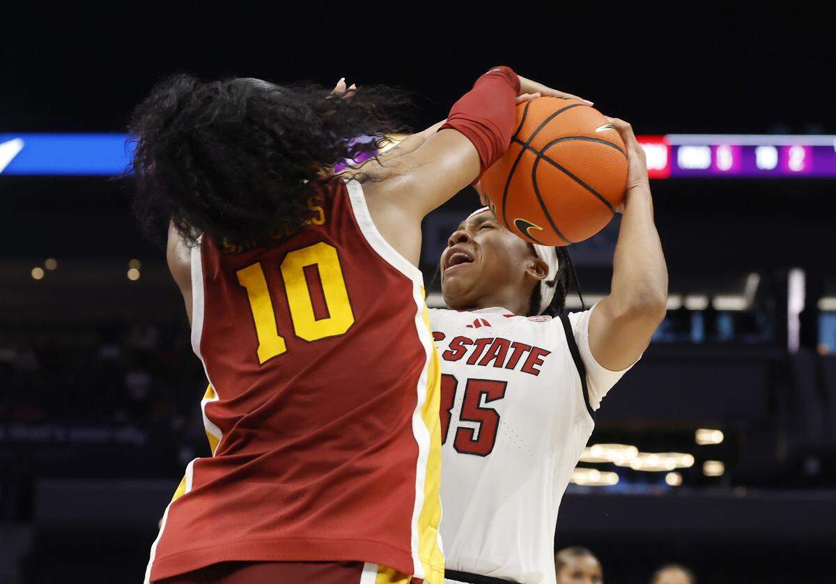 N.C. State’s Zoe Brooks is met by the defense of Southern California’s Malia Samuels while driving to the lane during the final seconds of the Wolfpack’s 69-68 loss in the Ally Tipoff game on Sunday, Nov. 9, 2025, at Spectrum Center in Charlotte, North Caolina.