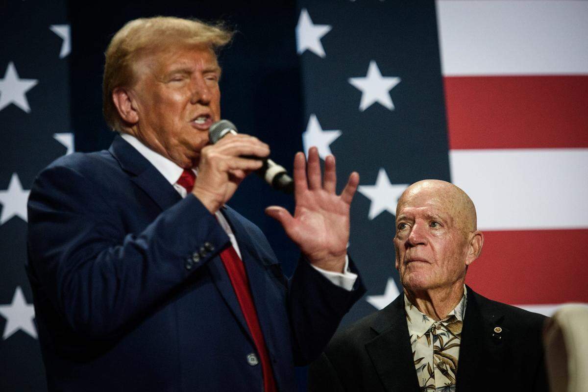 Veteran Dwight Francisco looks up at Republican presidential nominee and former U.S. President Donald Trump as he speaks at a town hall event at the Crown Arena on Friday, October. 4, 2024.