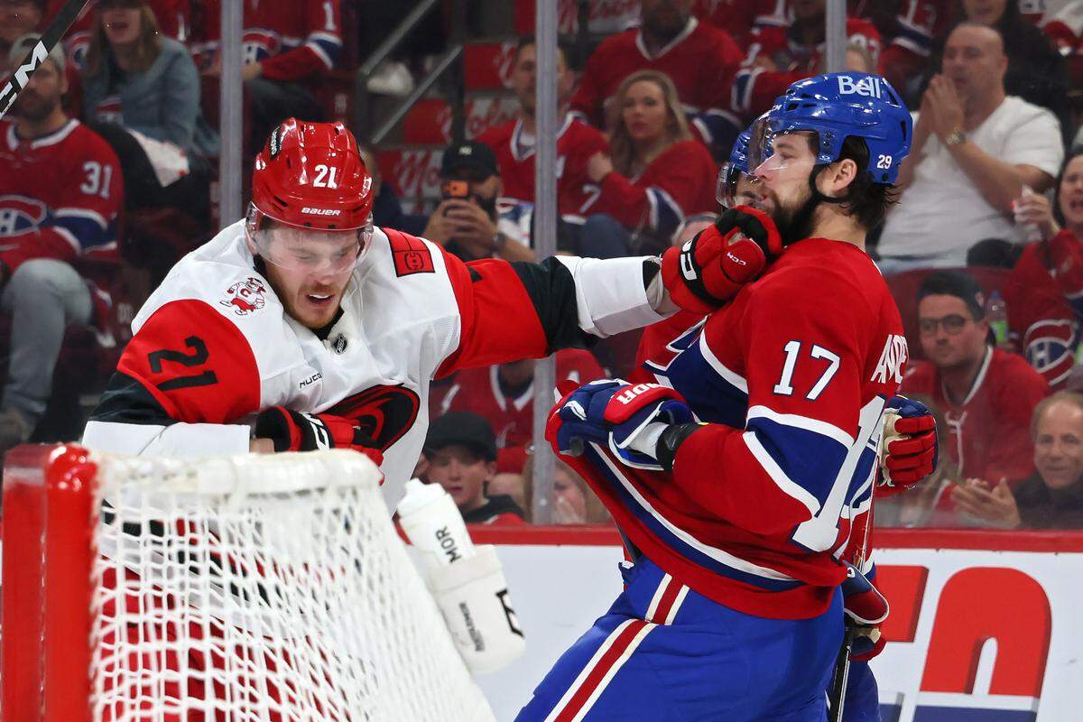 Alexander Nikishin #21 of the Carolina Hurricanes and Josh Anderson #17 of the Montreal Canadiens get into an altercation during the second period in Game Four of the Eastern Conference Final of the 2026 Stanley Cup Playoffs at Bell Centre on May 27, 2026 in Montreal, Quebec, Canada. 