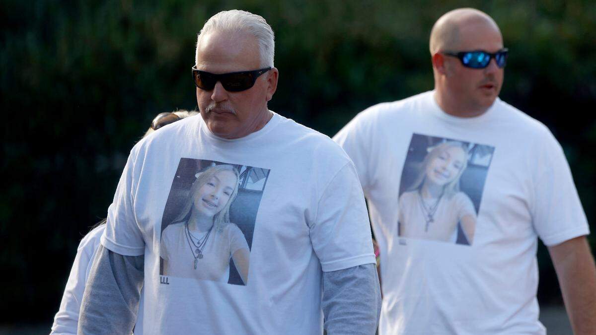 Stan Dean, the grandfather of Lyric Woods, left, and others exit the Orange County Courthouse following a hearing.