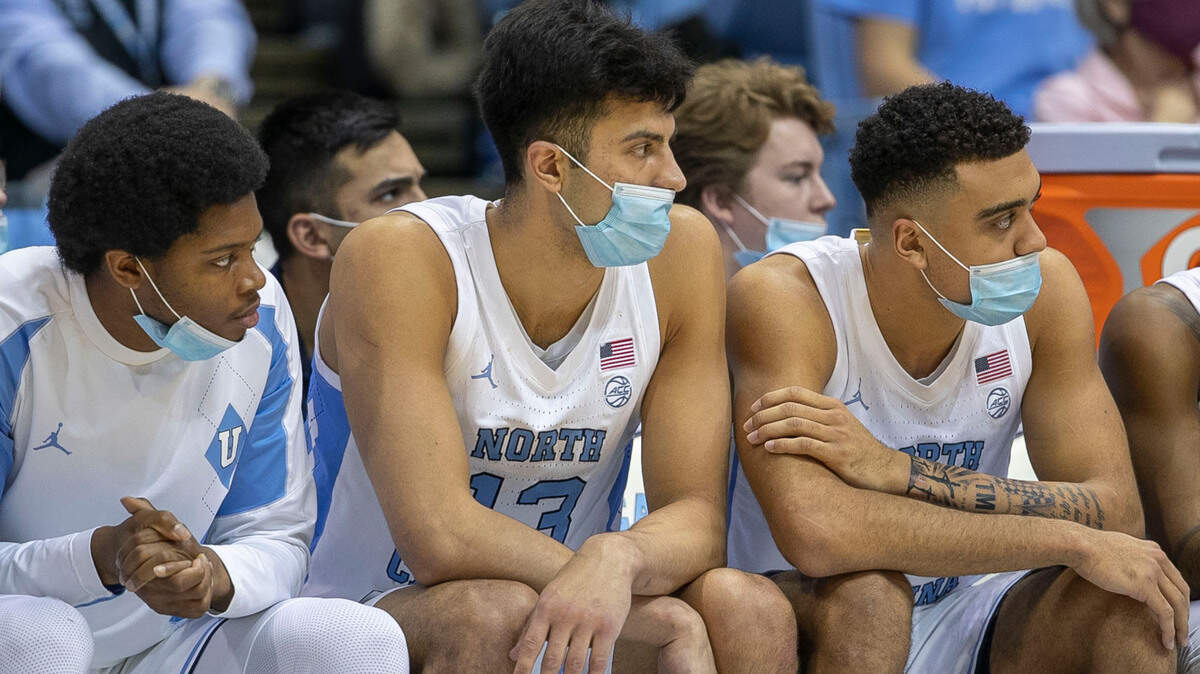 North Carolina’s Kerwin Walton (24), Dawson Garcia (13) and Justin McKoy (22) wear face covering on the North Carolina bench during their game against Appalachian State on Tuesday, December 21, 2021 at the Smith Center in Chapel Hill, N.C.