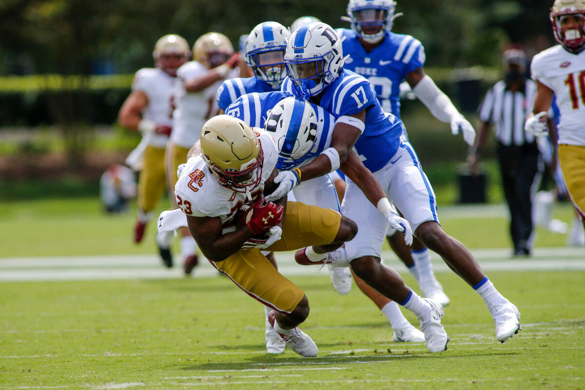 Boston College Eagles running back Travis Levy (23) holds onto the football as he is tackled by Duke Blue Devils safety Jaylen Stinson (16) and Duke Blue Devils safety Da’Quan Johnson (17) in the first quarter at Wallace Wade Stadium.