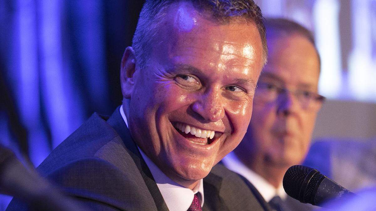 ECU coach Mike Houston smiles as he listens to N.C. State coach Dave Doeren during the 17th annual Pigskin Preview on Friday, July 19, 2019 at the Embassy Suites in Cary, N.C.