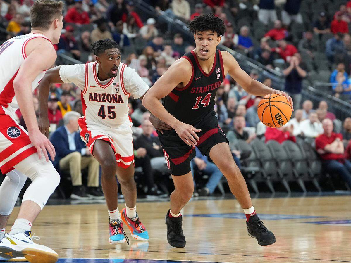 Stanford Cardinal forward Spencer Jones (14) dribbles against Arizona Wildcats guard Cedric Henderson Jr. (45) during the first half at T-Mobile Arena.