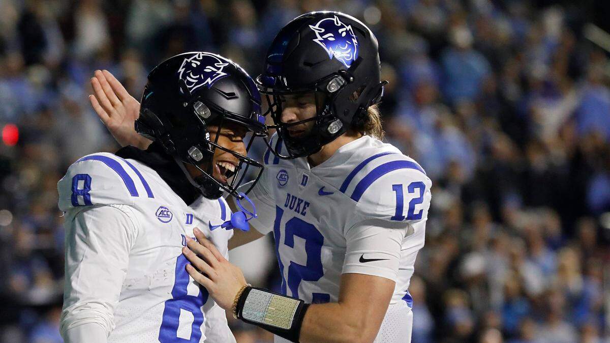 Duke’s Jordan Moore is congratulated by teammate Grayson Loftis after he scored a touchdown during the first half of the Blue Devils’ game against North Carolina on Saturday, Nov. 11, 2023, at Kenan Stadium in Chapel Hill, N.C.