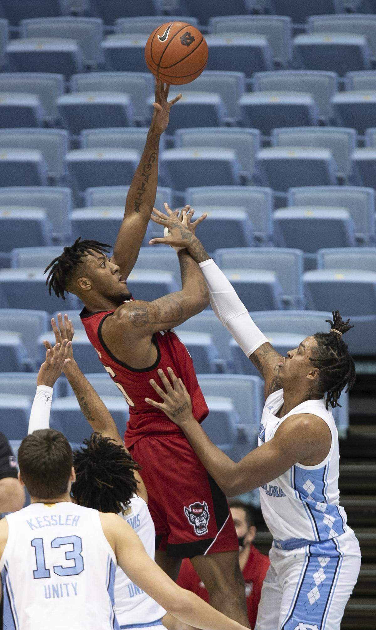 N.C. State’s Manny Bates (15) puts up a shot over North Carolina’s Armando Bacot (5) in the second half on Saturday, January 23, 2021 at the Smith Center in Chapel Hill, NC.