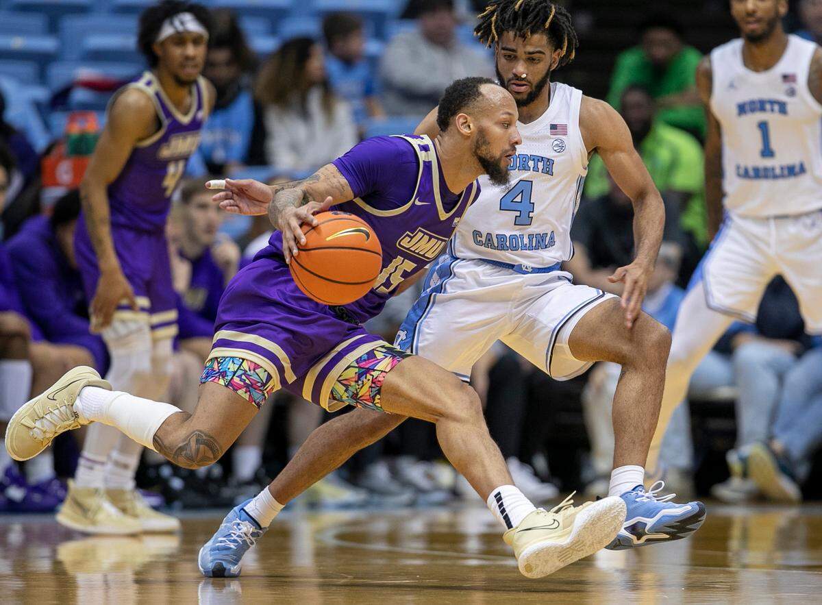 North Carolina’s R.J. Davis (4) defends James Madison’s Takal Molson (15) in the second half on Sunday, November 20, 2022 at the Smith Center in Chapel Hill, N.C.