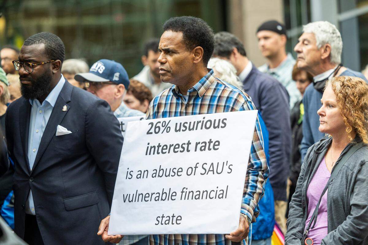 Dozens of clergy members, civil rights activists, and St. Augustine’s University alumni gather at City Plaza in Raleigh on Wednesday, Nov. 20, 2024, to rally for more favorable terms on a multi-million dollar loan for the struggling historically Black university.