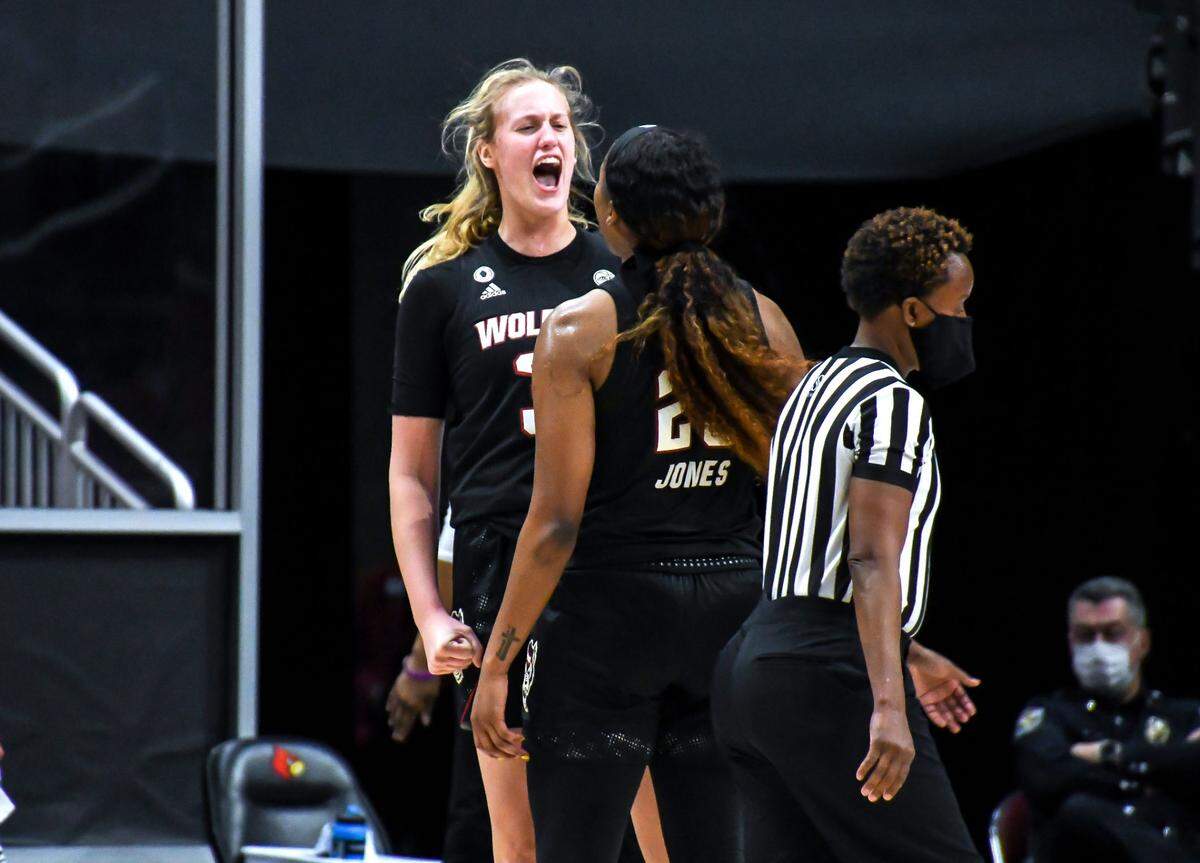 N.C. State’s Elissa Cunane (33) celebrates with Kayla Jones (25) during the Wolfpack’s victory over Louisville at KFC Yum! Center in Louisville, Ky. Monday, February 1, 2021.