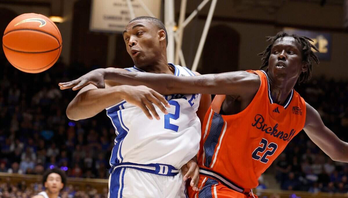 Duke’s Jaylen Blakes (2) and Bucknell’s Ruot Bijiek (22) go after the rebound during the first half of Duke’s game against Bucknell at Cameron Indoor Stadium in Durham, N.C., Friday, Nov. 17, 2023.