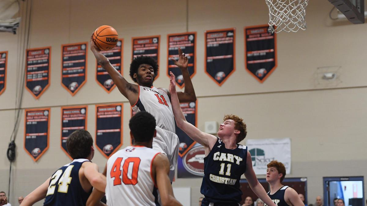 Jaylon Gibson, center, of Grace Christian wins a rebound against Seth Cullen, second from right, of Cary Christian. The Cary Christian Knights visited the Grace Christian Raleigh Eagles in a high school boys basketball game on January 24, 2020.