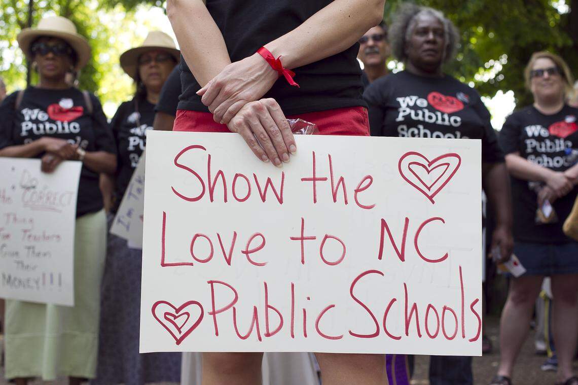 A participant at a 2014 rally in Raleigh, NC shows her support of North Carolina public schools. According to research published in February 2023, an increasing number of teachers are leaving NC public schools, and some of the state’s rural areas are experiencing the worst teacher attrition. 