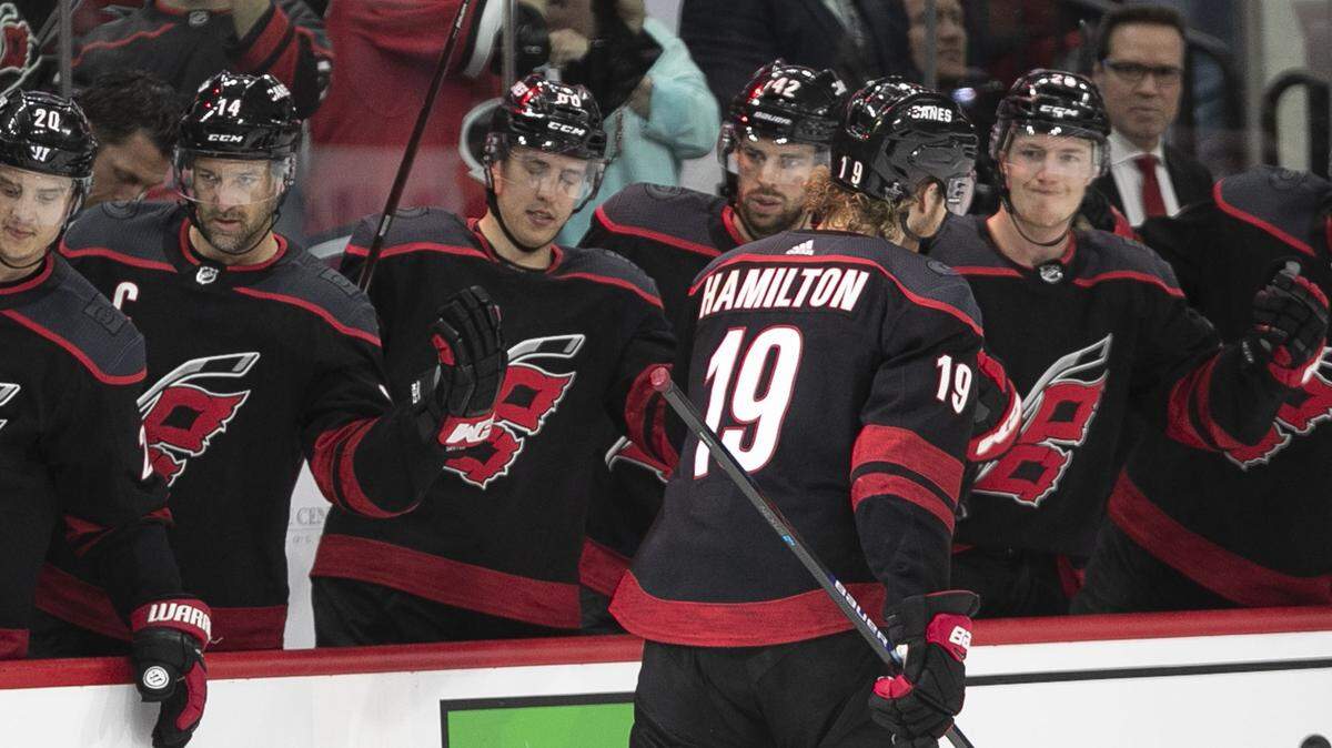 Carolina Hurricanes’ Dougie Hamilton (19) celebrates with the bench after scoring in the third period against Washington on Monday, April 15, 2019 at the PNC Arena on Raleigh, N.C.
