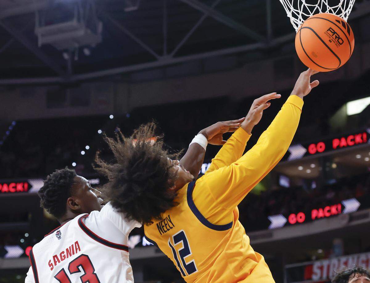N.C. State’s Musa Sagnia battles UNC Greensboro’s Justin Neely for a rebound during the first half of the Wolfpack’s 110-64 win on Wednesday, Nov. 12, 2025, at Lenovo Center in Raleigh, N.C.