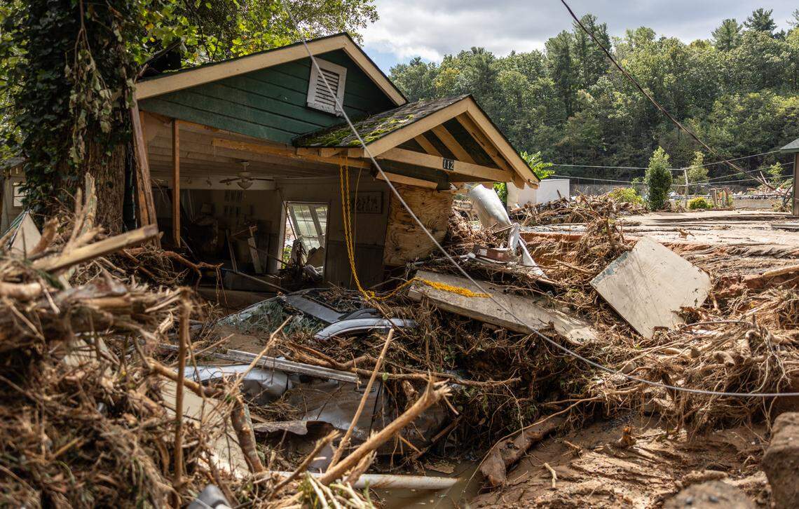 A destroyed house with a car under it in Chimney Rock, N.C. on Sunday, September 29, 2024.