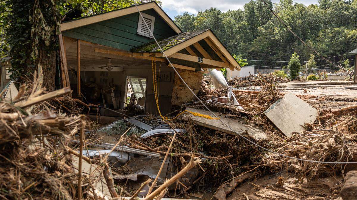 A destroyed house with a car under it in Chimney Rock, N.C. on Sunday, September 29, 2024.