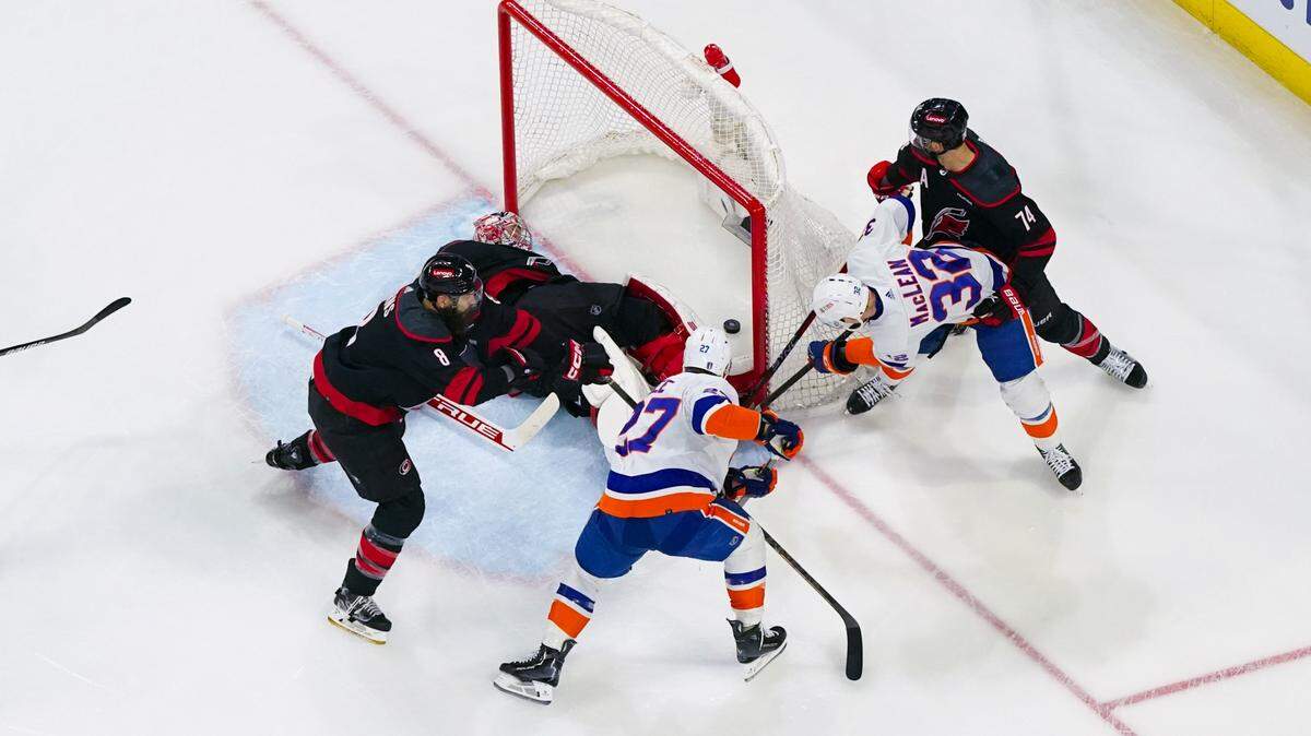 New York Islanders center Kyle MacLean (32) scores a goal past Carolina Hurricanes goaltender Frederik Andersen (31) during the first period in game one of the first round of the 2024 Stanley Cup Playoffs at PNC Arena.