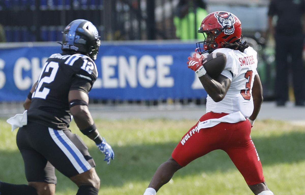 N.C. State running back Hollywood Smothers (3) pulls in the reception while being trailed by Duke linebacker Tre Freeman (12) during the first half of N.C. State’s game against Duke at Wallace Wade Stadium in Durham, N.C., Sat. Sept. 20, 2025