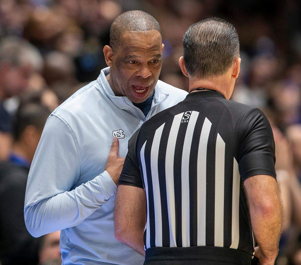 North Carolina coach Hubert Davis has a word with official Roger Ayers in the second half against Duke on Saturday, February 4, 2023 at Cameron Indoor Stadium in Durham, N.C.